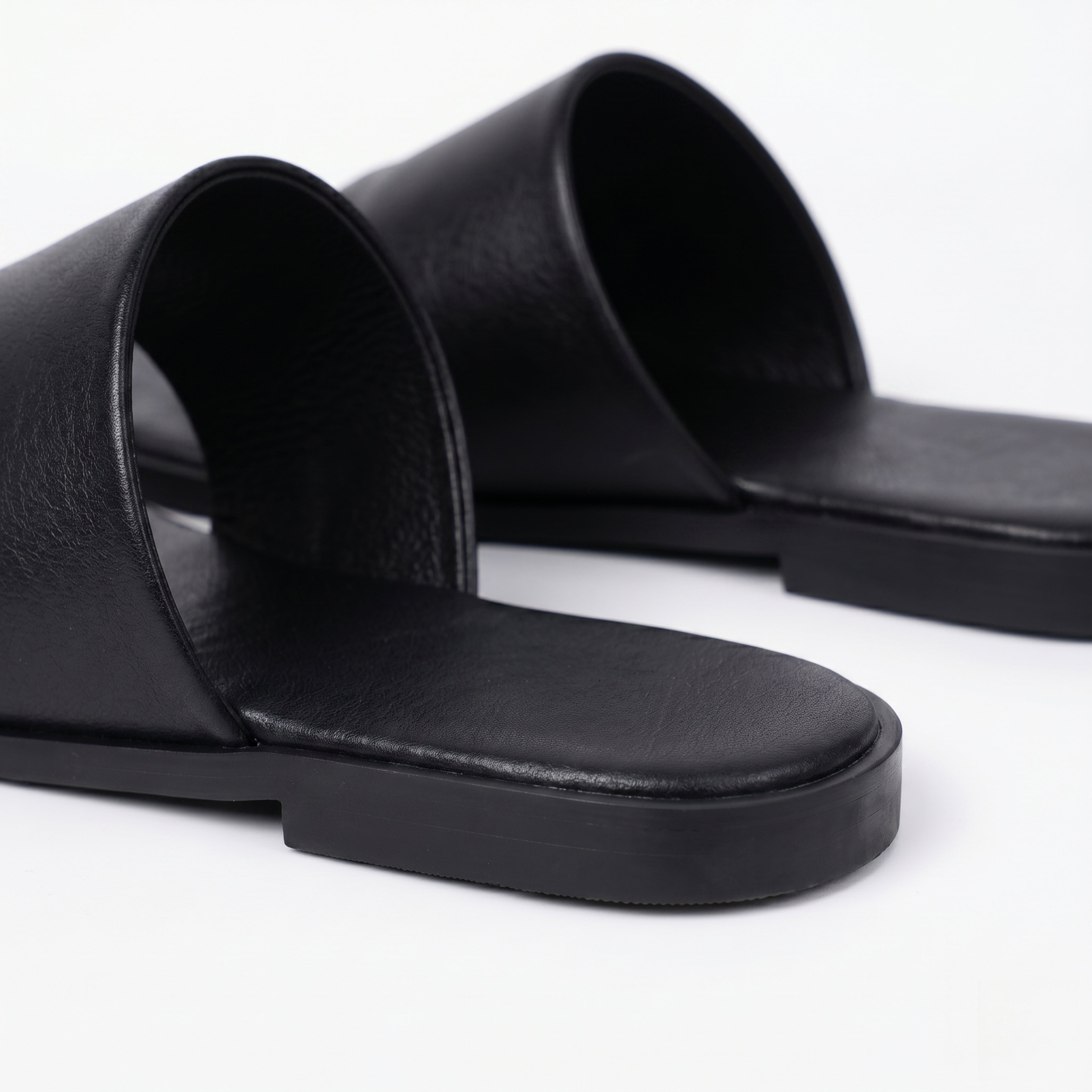 The Dual Stride Black Calfskin Thong Sandals